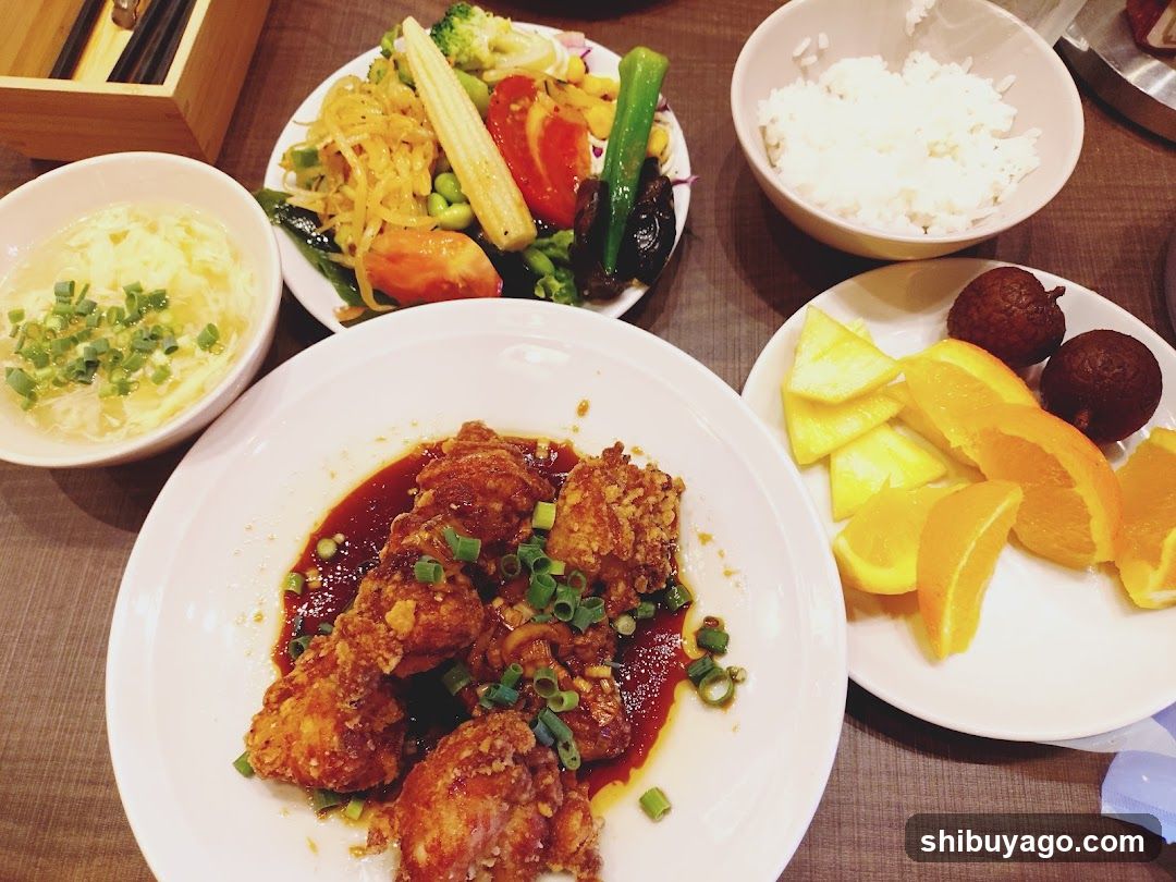 Bowl of food with rice, fruit and vegetables