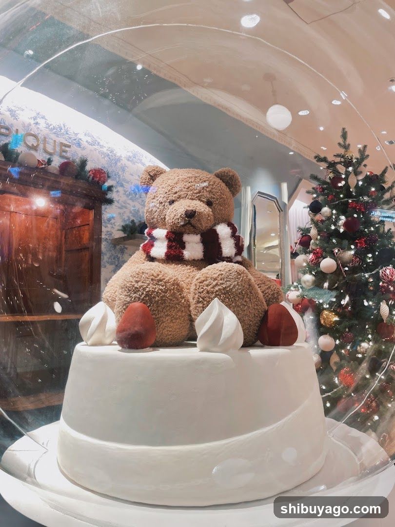 Christmas-themed cake display with teddy bear