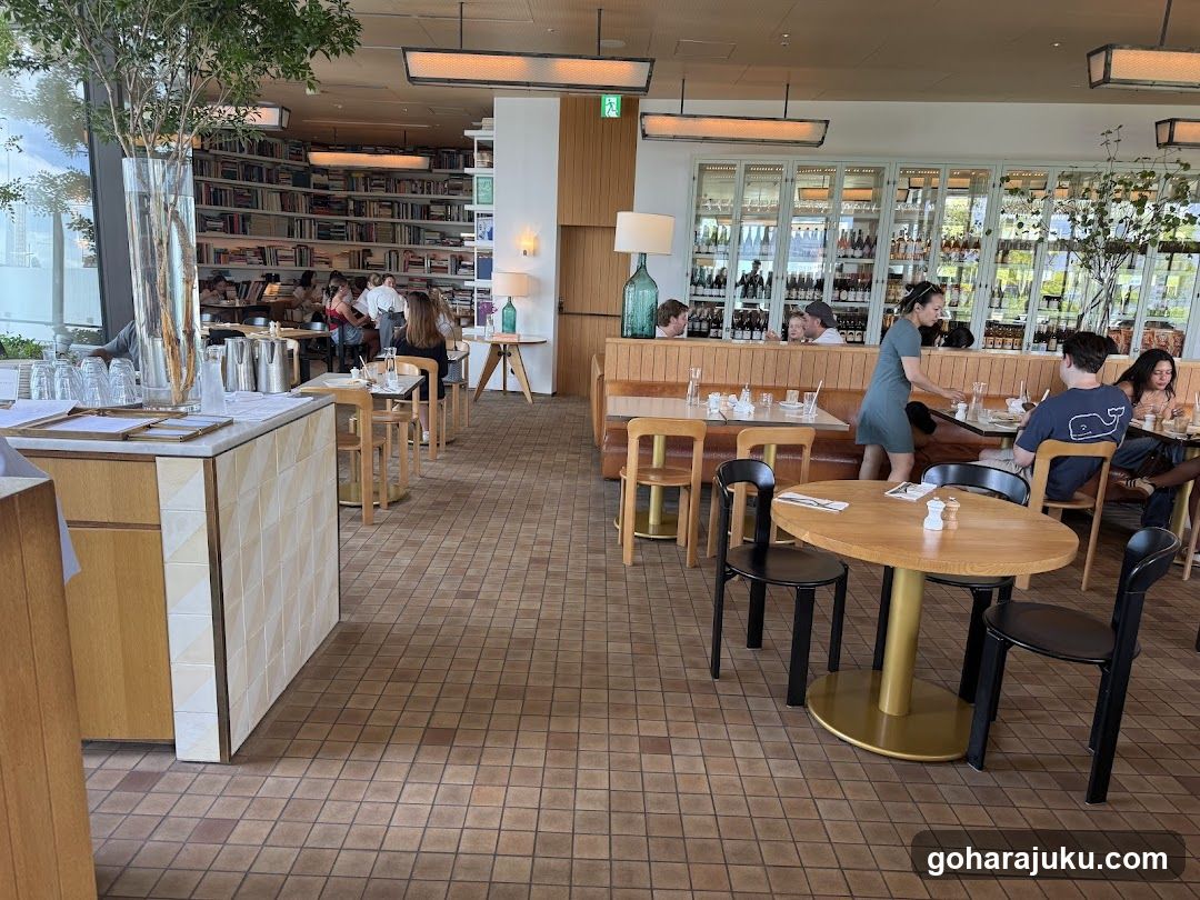 Interior of a modern café or restaurant with bookshelves and dining area