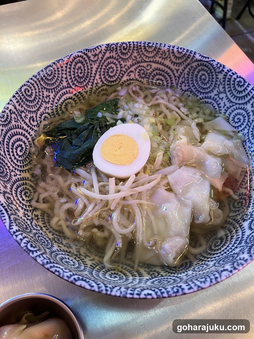 Bowl of Noodles with Halved Egg and Greens