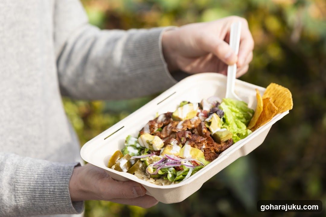 Person Holding a Takeout Meal