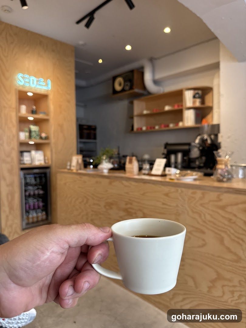 Coffee Shop Interior with Cup in Foreground