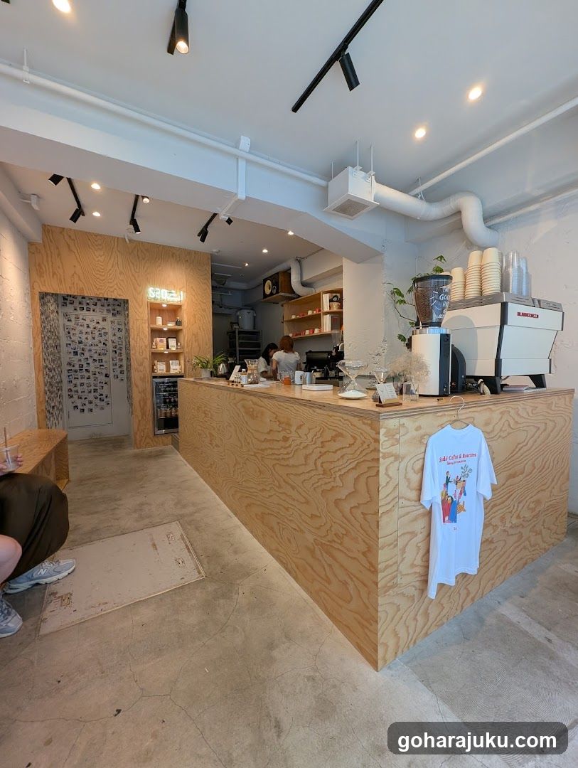 Interior of a coffee shop with wooden counter and barista at work