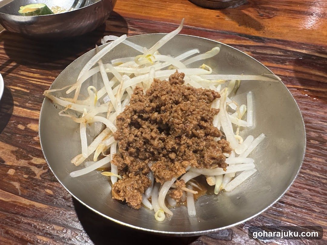 Bowl of bean sprouts with ground meat topping
