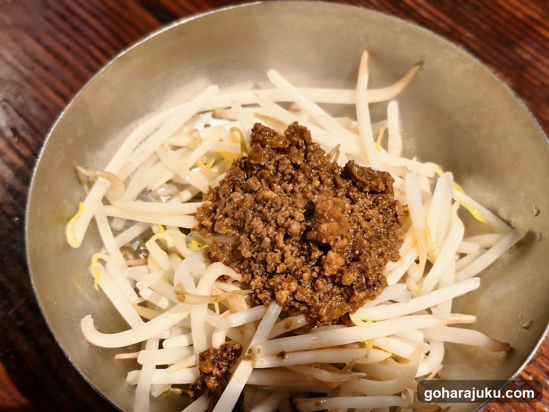 Bowl of bean sprouts with minced meat topping