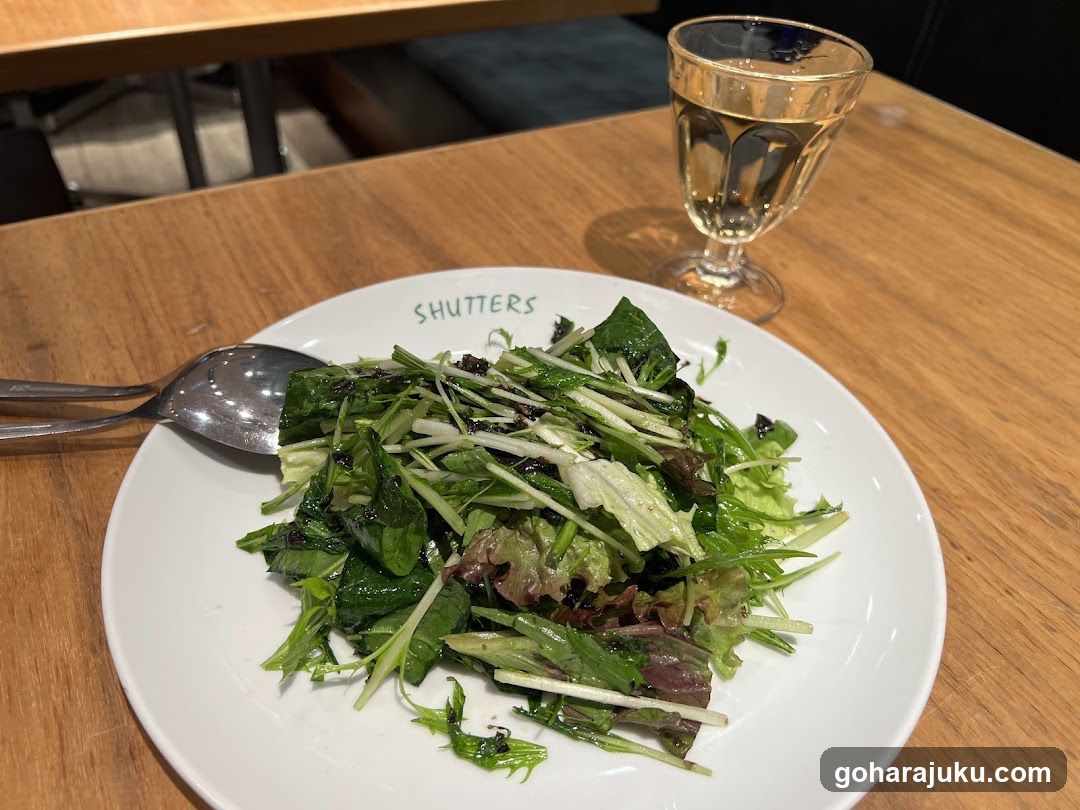 Salad with Glass of Water on Wooden Table