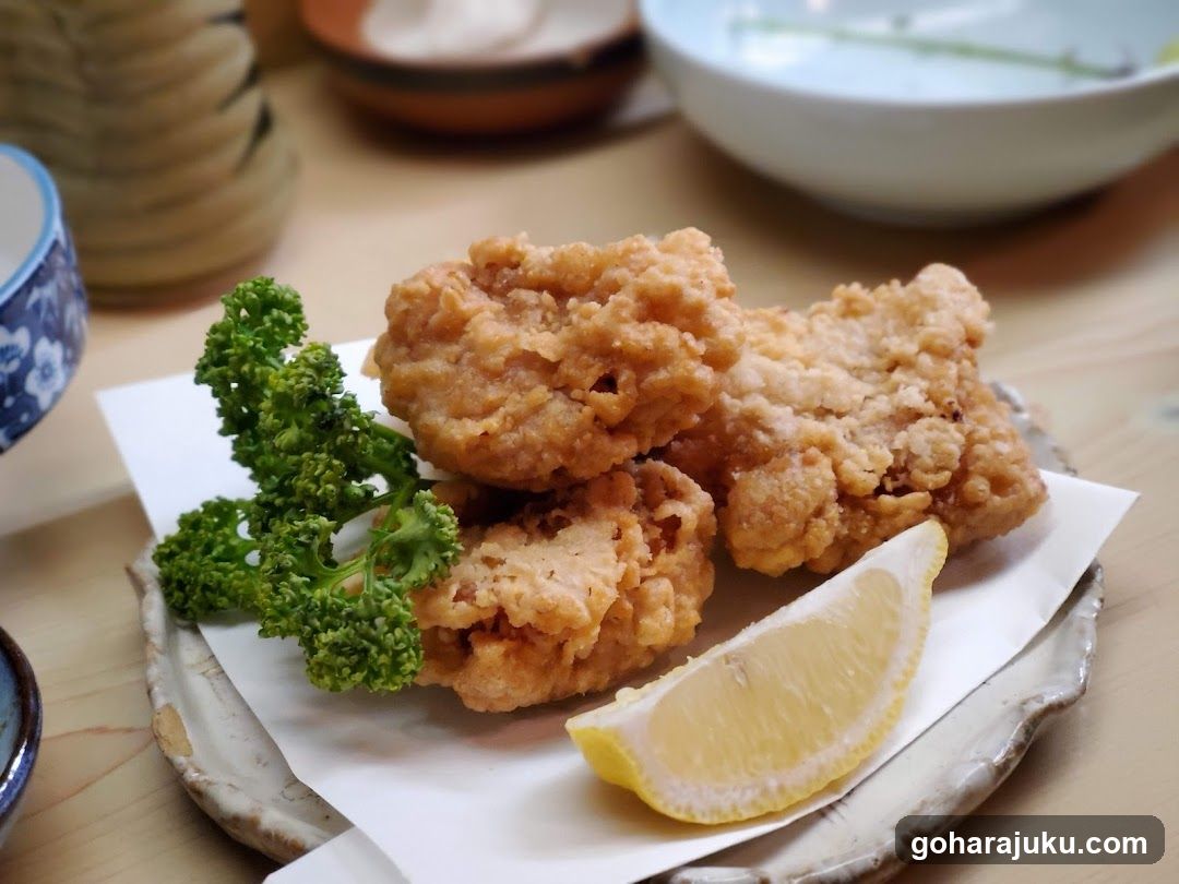 Fried Chicken with Lemon Wedge and Kale Garnish