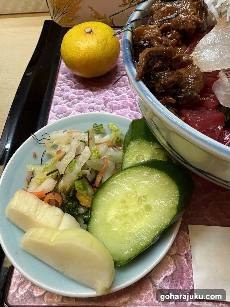 Bowl of food with side dish and fruit