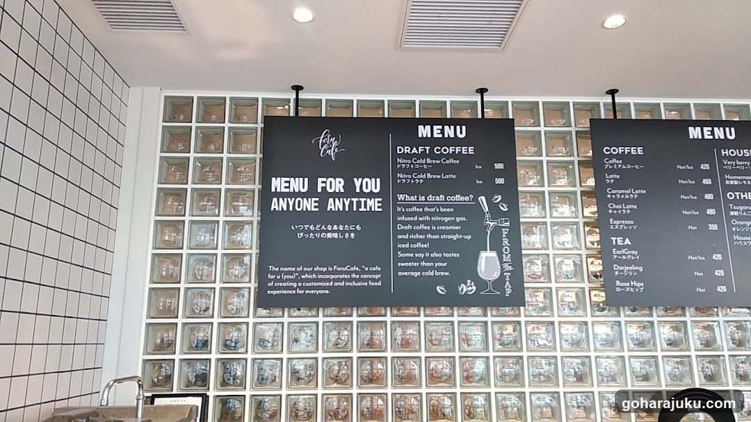 Interior of a coffee shop with menu boards and glass block wall