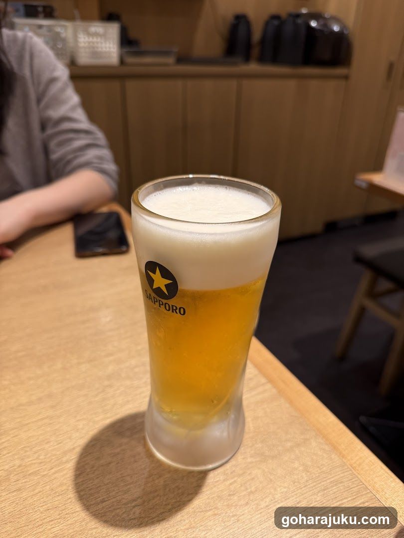 Sapporo Beer Glass on Wooden Table