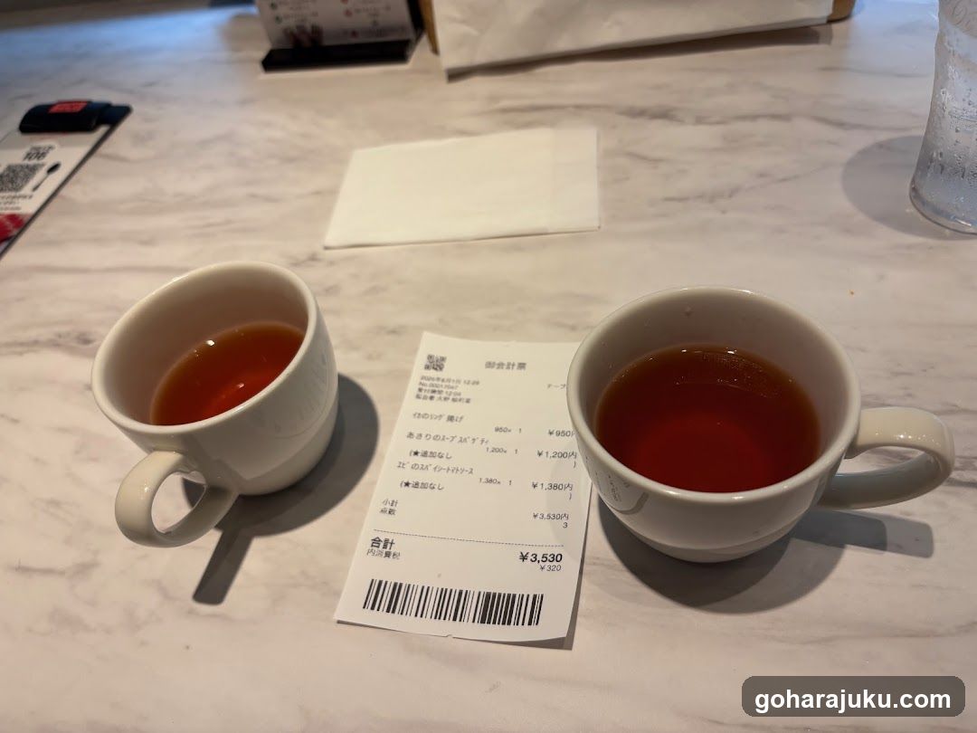 Tea cups and receipt on marble table