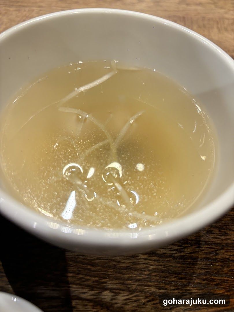Bowl of clear soup with bean sprouts