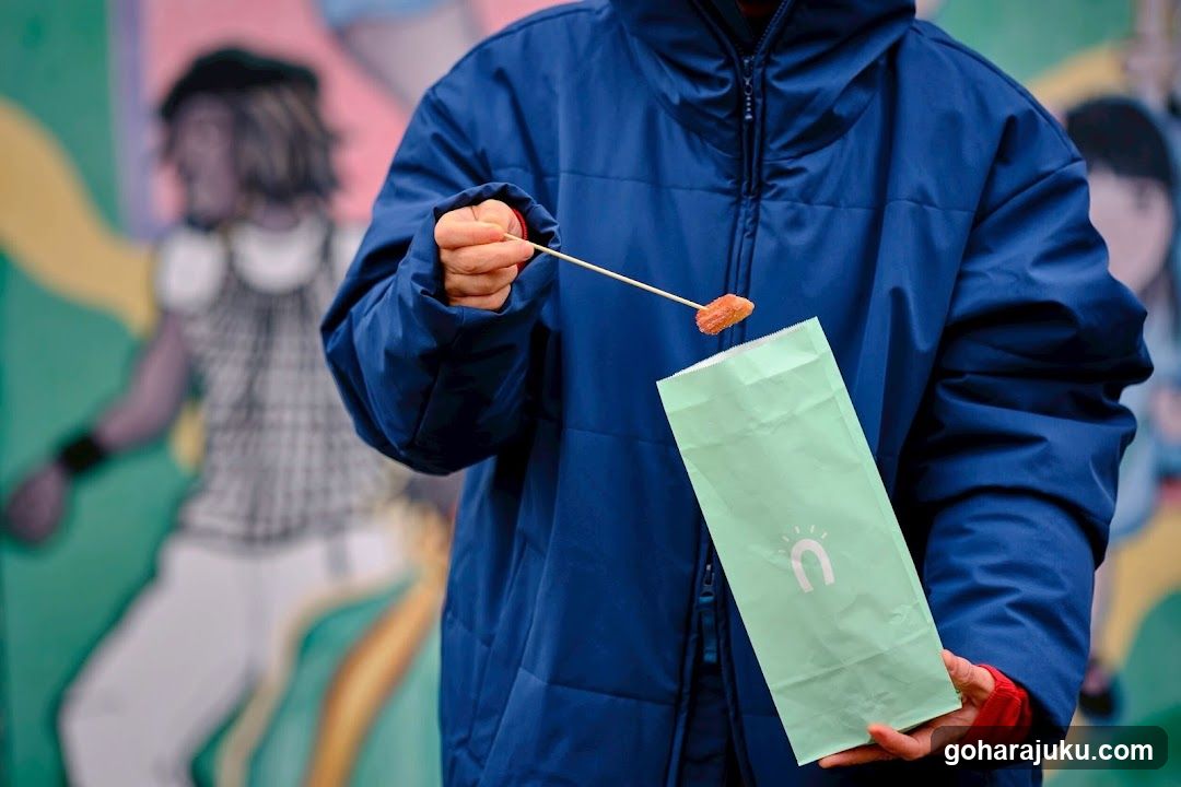 Person holding food item and bag