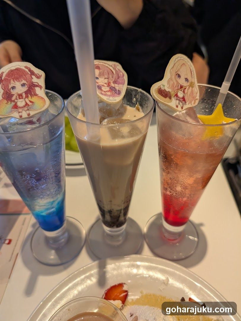 Three colorful drinks with anime-themed stirrups