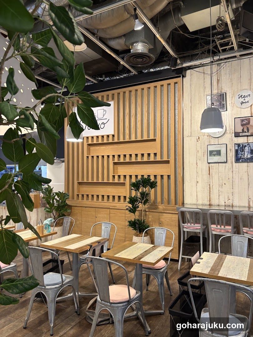 Interior of a modern café with wooden decor and metal chairs