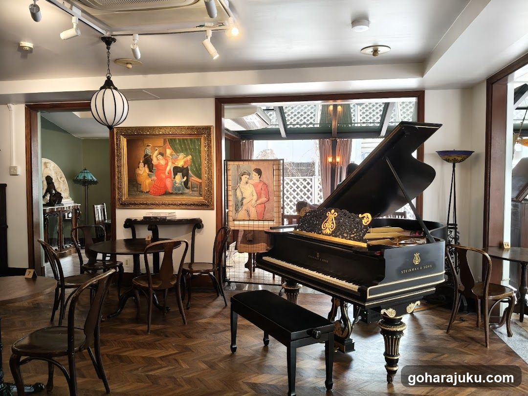 Interior of a music-themed room with grand piano and artwork