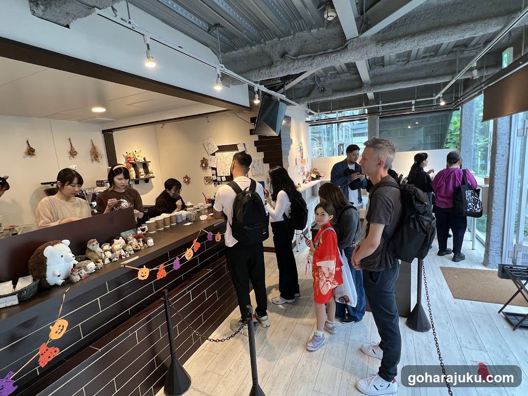 Interior of a cafe or shop with customers and staff
