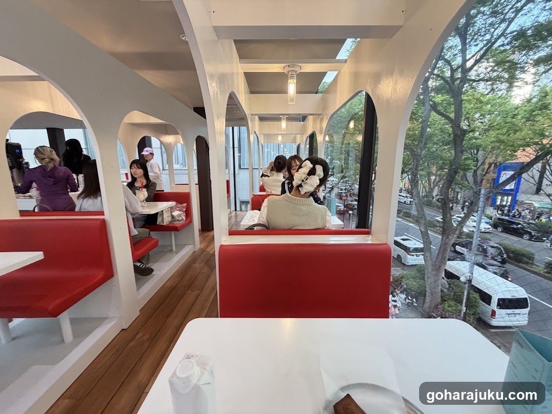 Cafe Interior with Red Booths and Large Windows