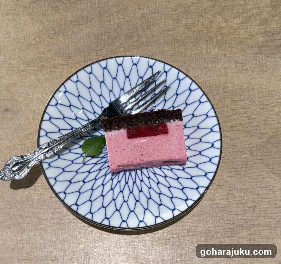 Slice of Pink Layered Cake on Patterned Plate