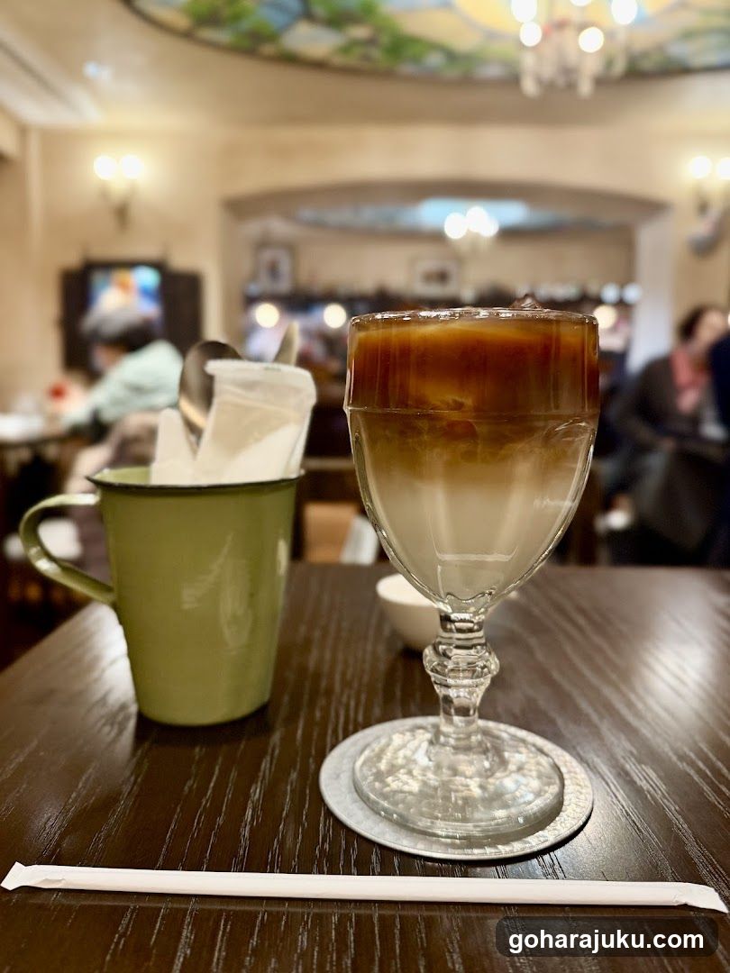 Iced Coffee and Mug in Cafe Interior