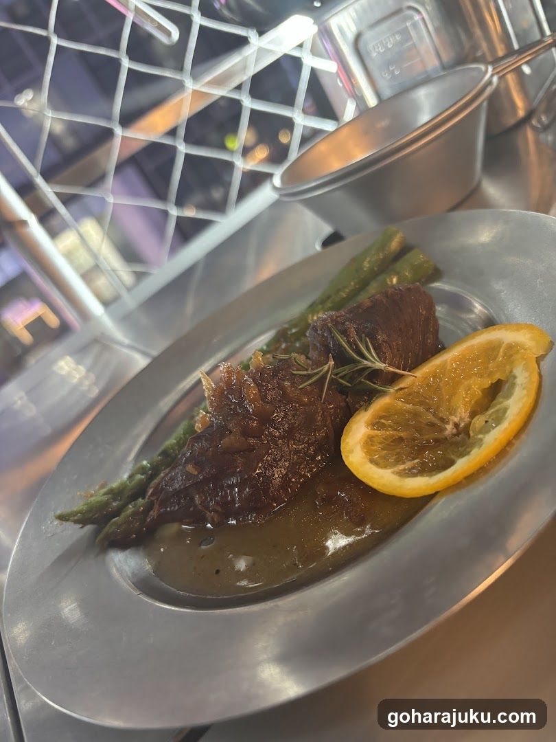 Plated Meat Dish with Asparagus and Orange Slice