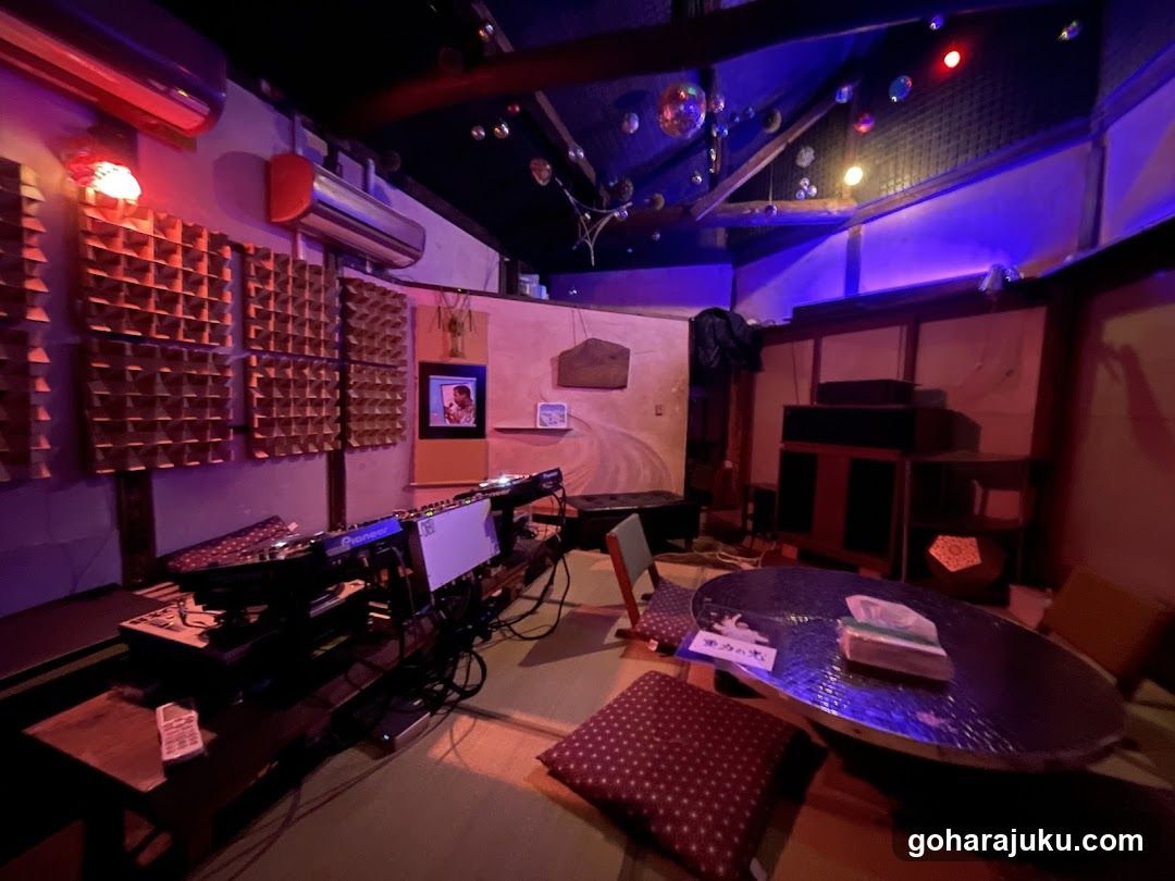 Interior of a dimly lit room with audio equipment and seating area