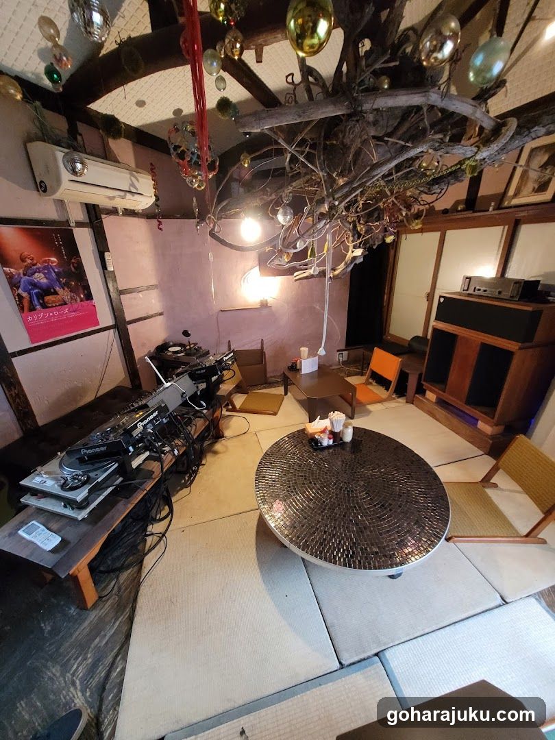 Interior of a Japanese-style room with DJ equipment and mosaic table
