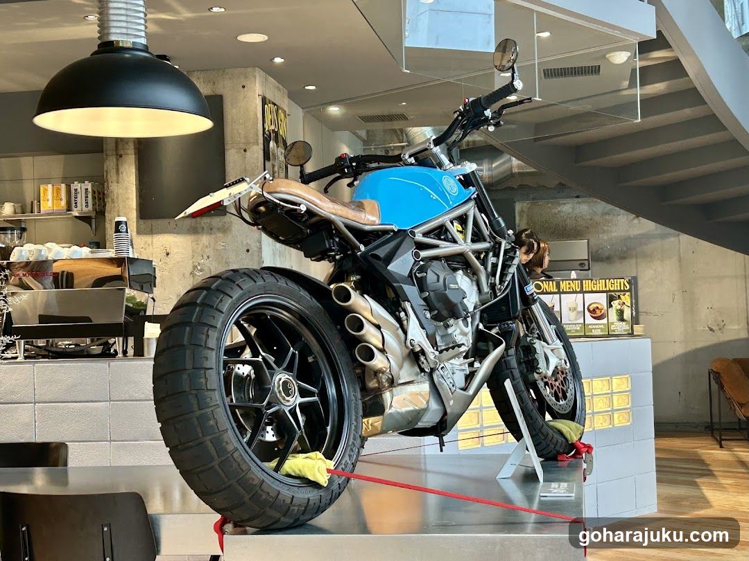 Blue Motorcycle Display in Coffee Shop Interior