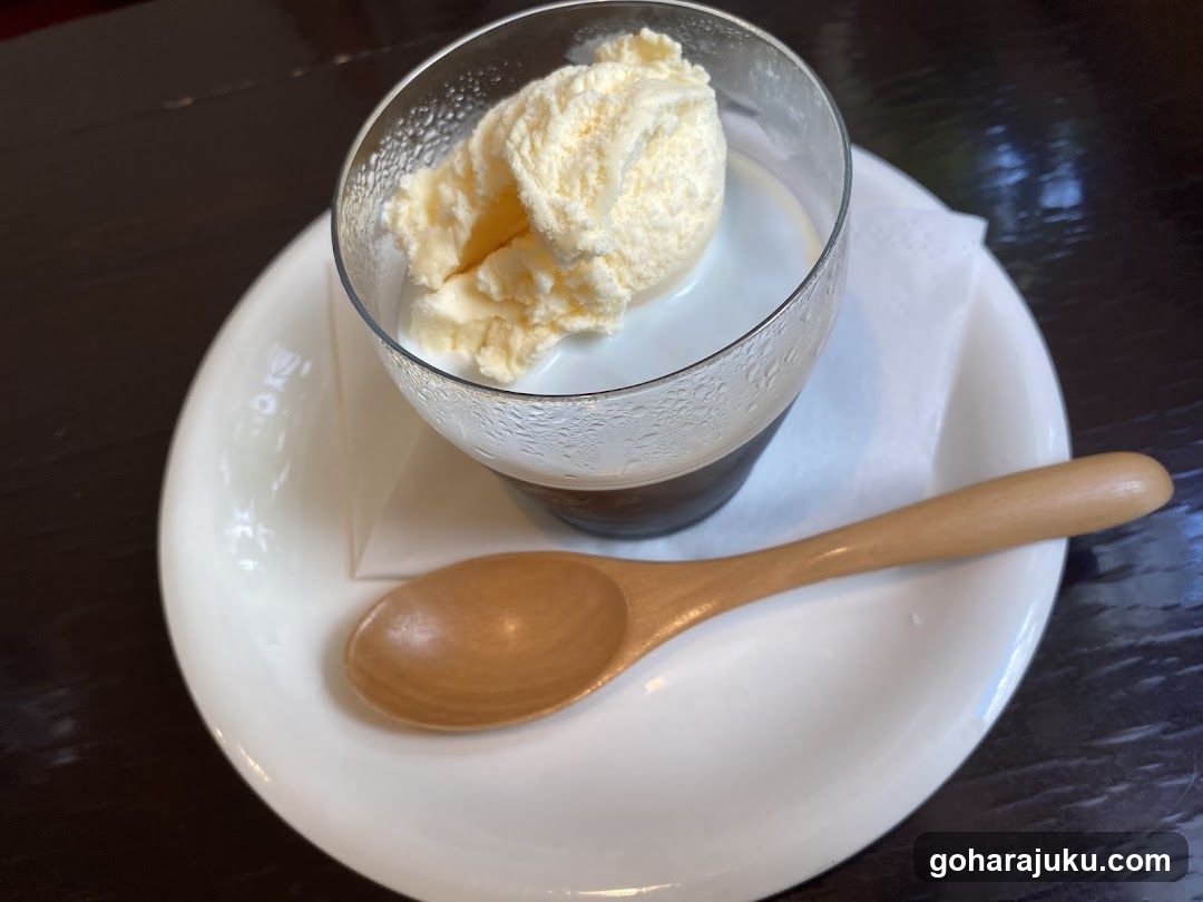 Ice cream dessert in glass with wooden spoon