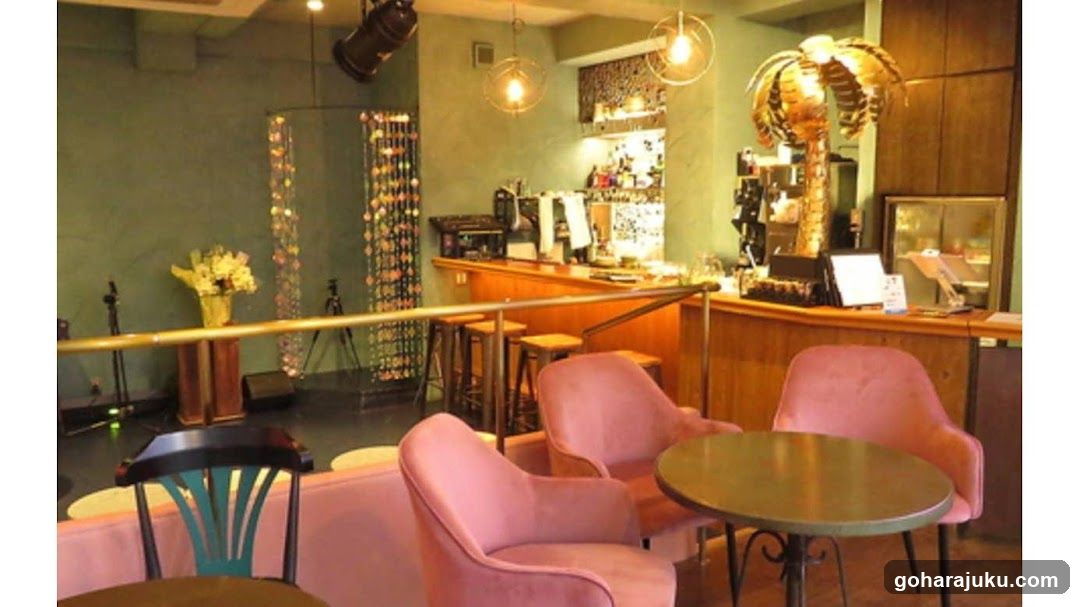 Interior of a cafe or bar with pink chairs and wooden counter