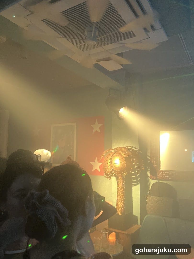Interior of a dimly lit venue with palm tree decor