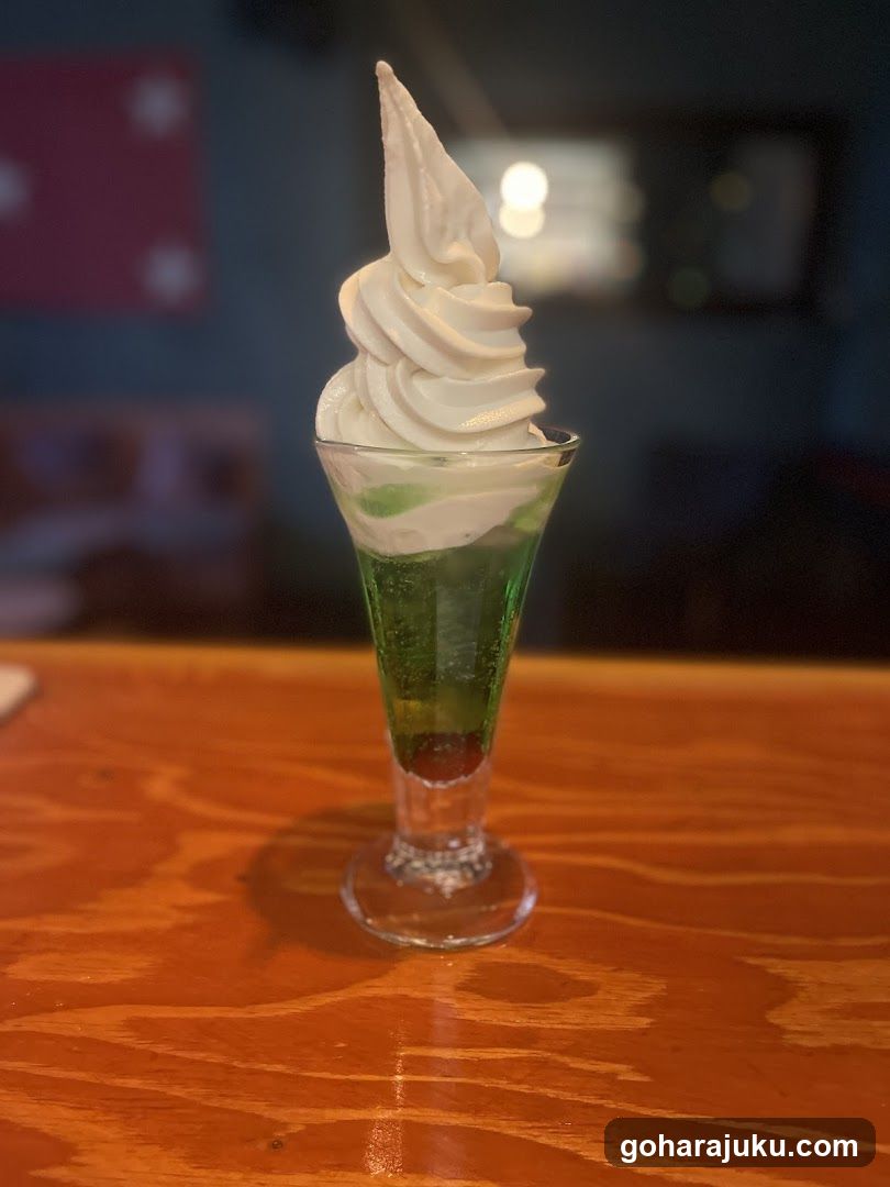 Green layered dessert with whipped cream