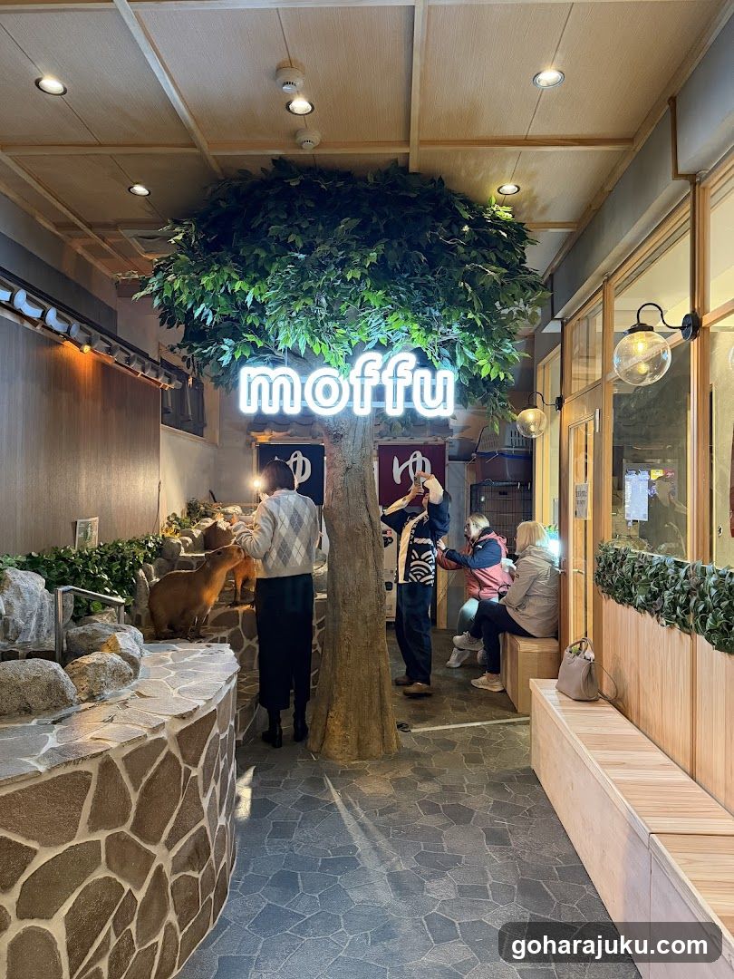 Interior of a cafe with artificial tree and neon sign