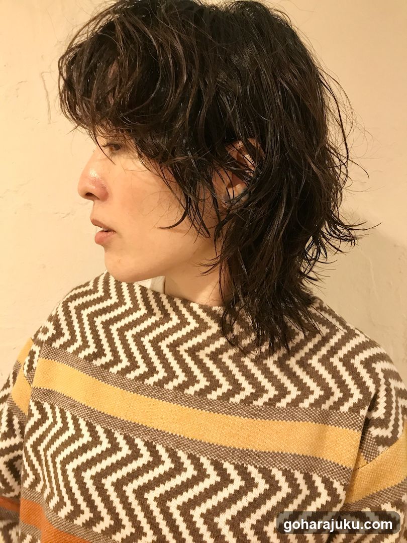 Portrait of person with wet hair wearing patterned sweater