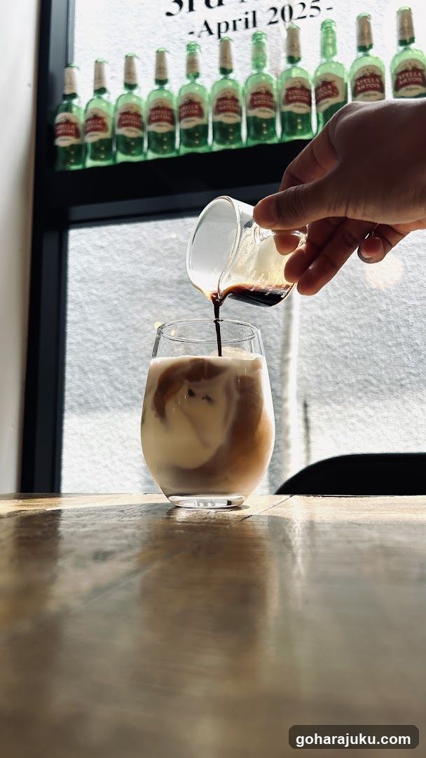 Pouring espresso into iced coffee