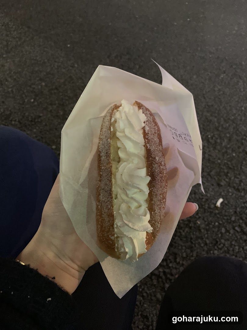 Cream-filled pastry in paper wrapper