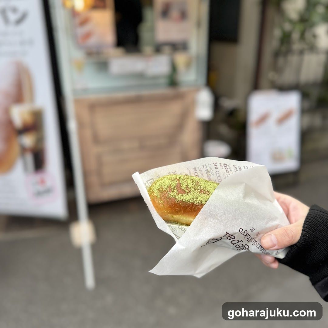 Hand holding a matcha bun