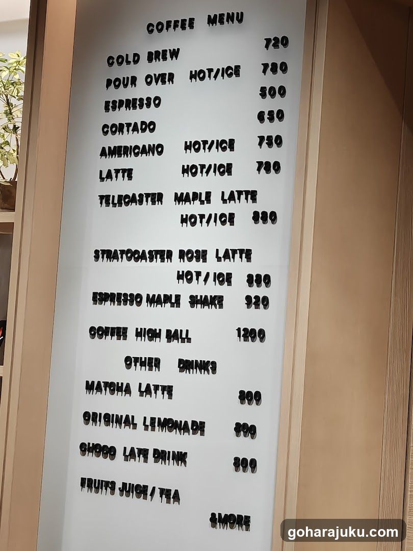 A vertical menu board displaying coffee and other drink options with prices in what appears to be a casual cafe setting.