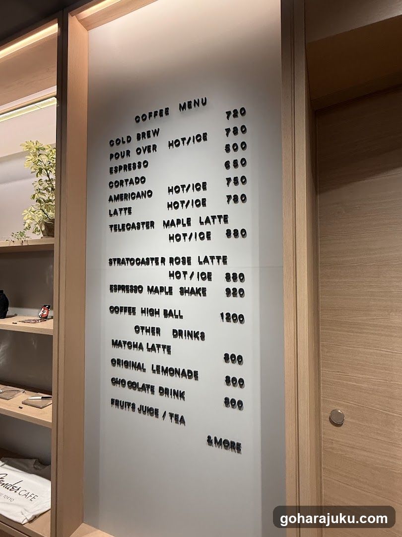 A frosted glass menu board mounted on a wooden frame, displaying coffee and other drink options with prices in Thai Baht.