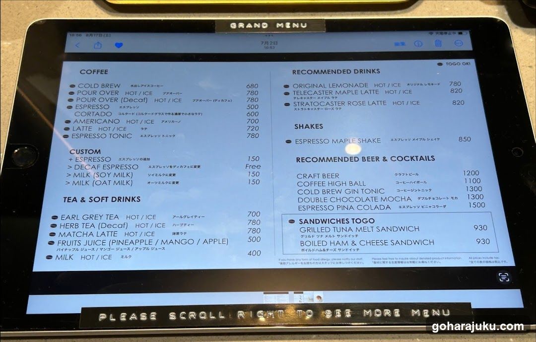 A tablet screen displaying a digital menu with coffee, recommended drinks, shakes, beer & cocktails, sandwiches, and tea/soft drink options.