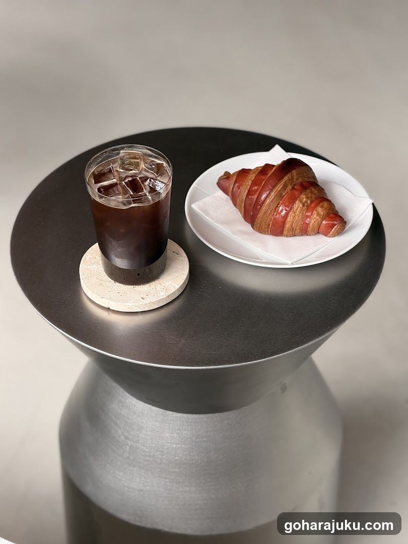 Croissant and Iced Coffee on Modern Table
