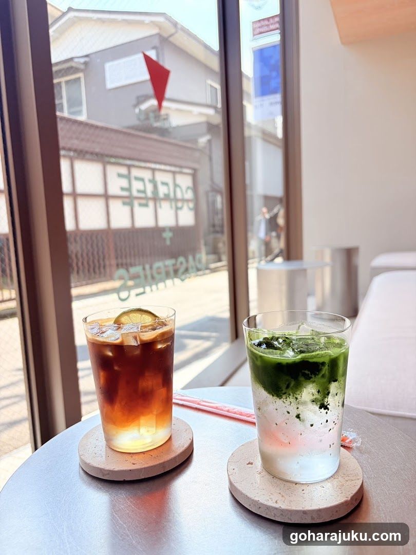 Two iced drinks on a table by the window
