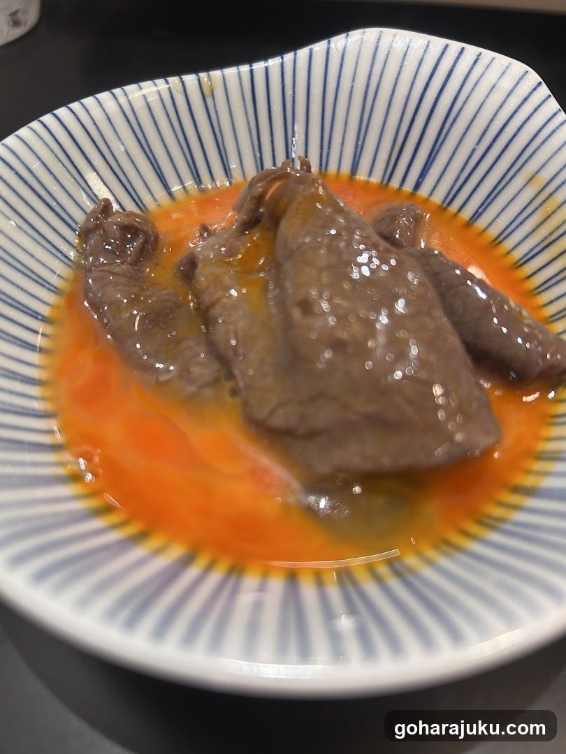 Bowl of cooked meat in broth