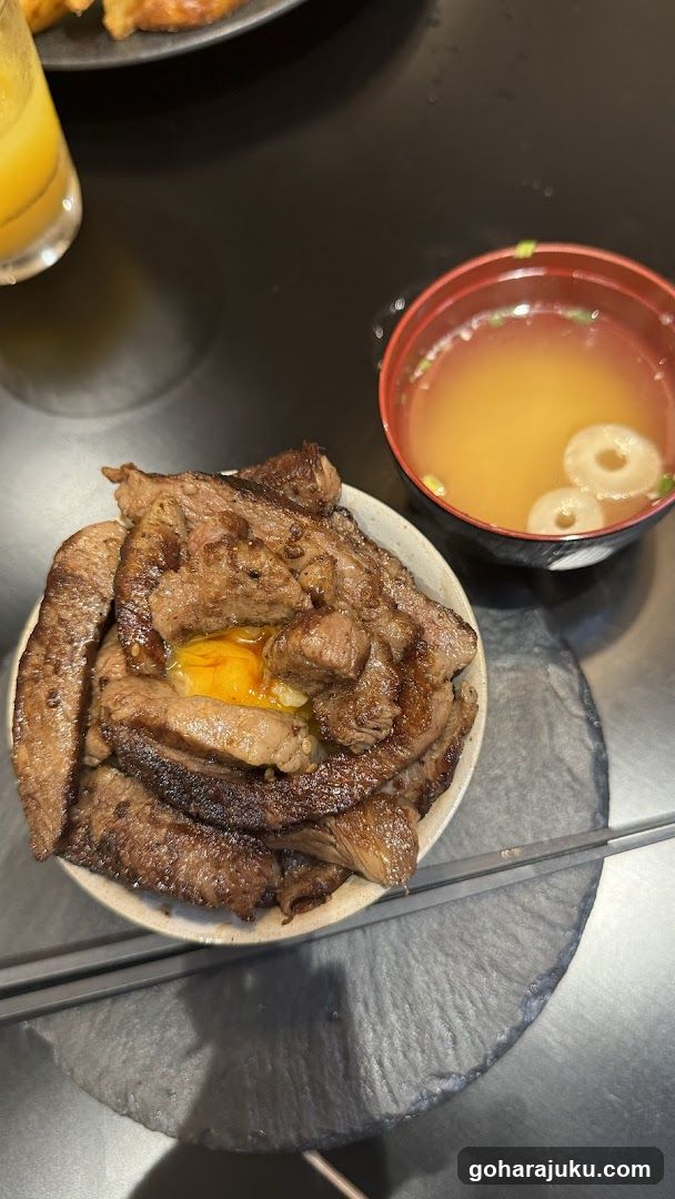 Bowl of Grilled Meat with Egg Yolk and Soup