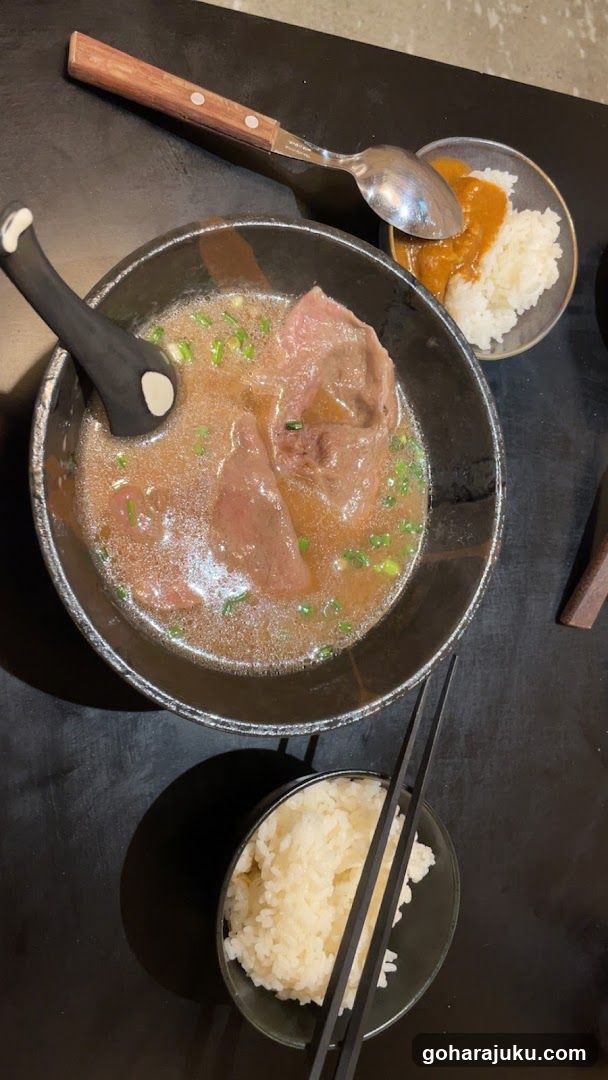 Bowl of Soup with Rice and Chopsticks