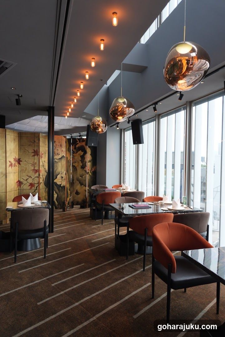 Modern Restaurant Interior with Large Windows and Hanging Lights