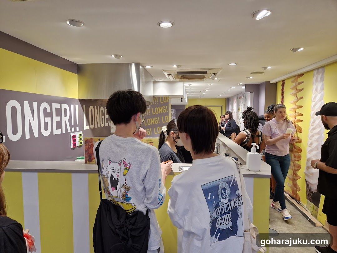 Interior of a food shop with customers waiting in line