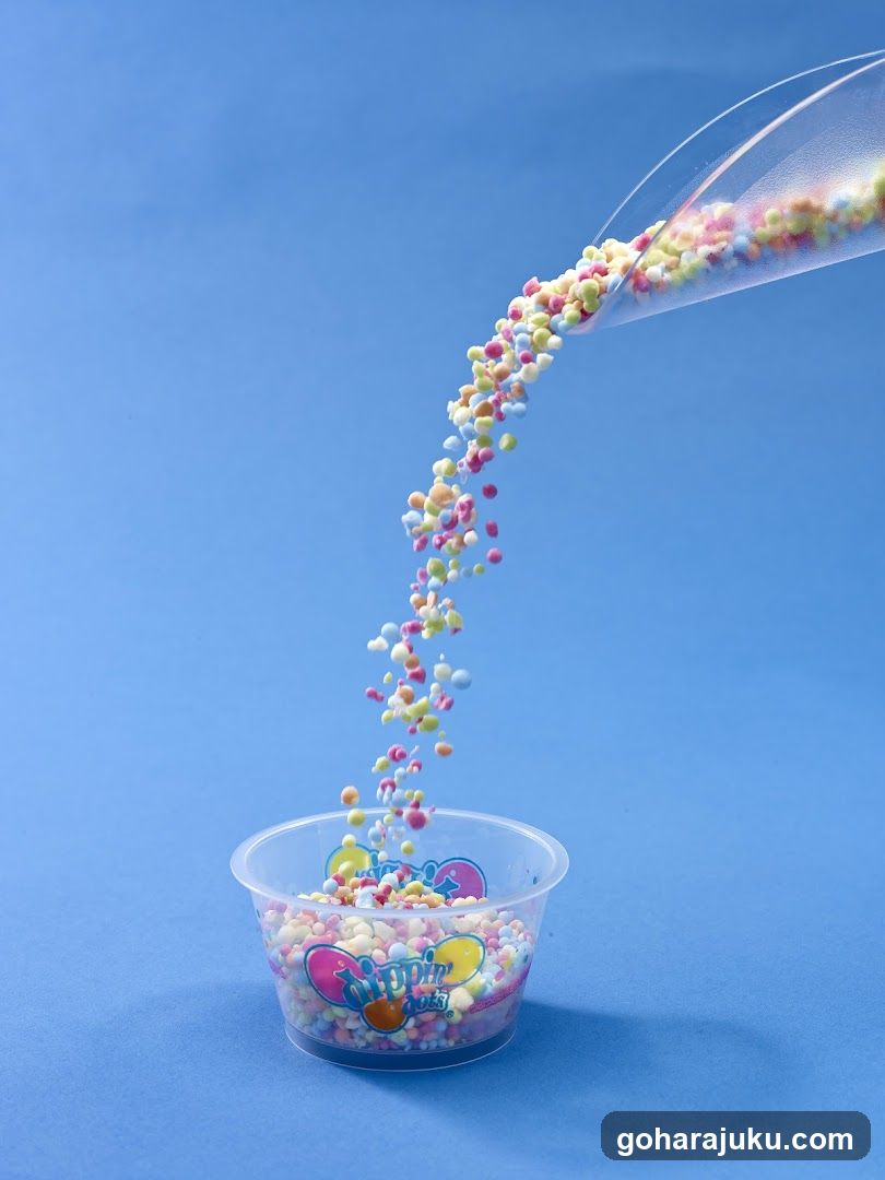 Colorful sprinkles being poured into a cup