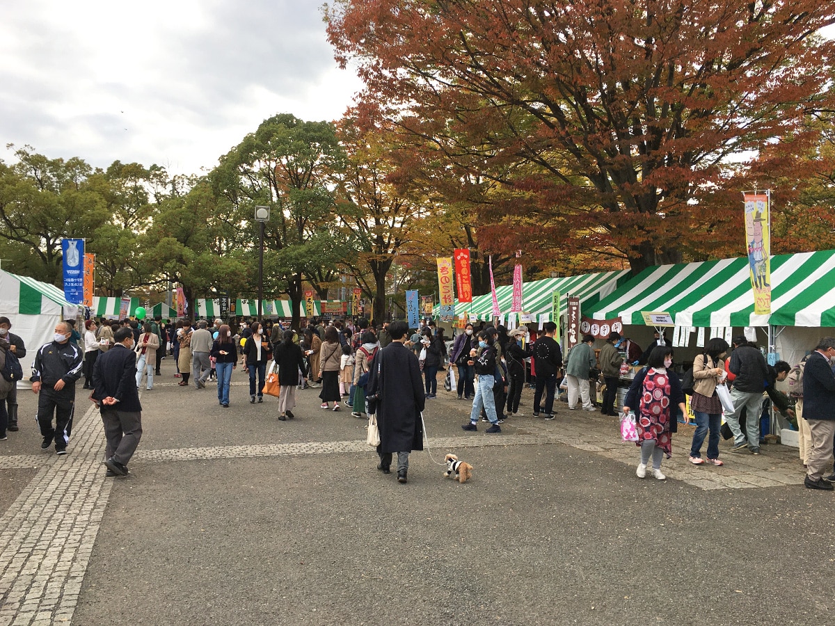 Green stall tents on the Yoyogi Park path at Furusato Shibuya Festival